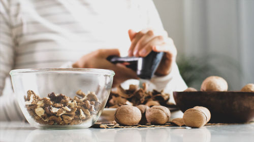 Midsection of woman having food at home