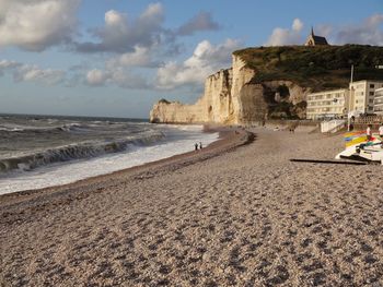 View of beach against cloudy sky