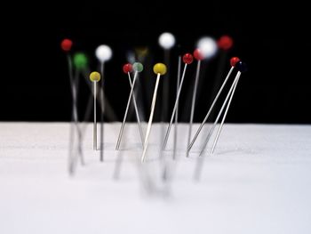 Close-up of straight pins on table