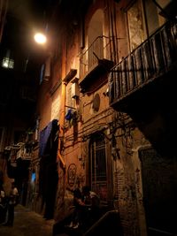 People in illuminated city at night