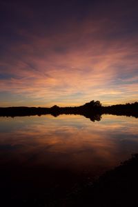 Scenic view of lake against romantic sky at sunset