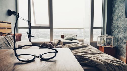 Close-up of eyeglasses on table by window