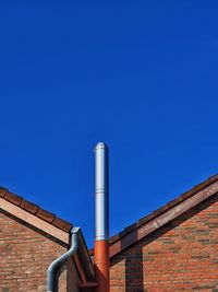 Low angle view of building against blue sky