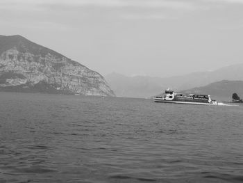 Boat sailing in sea against sky