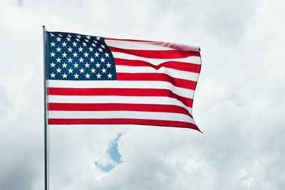 Low angle view of flag against sky