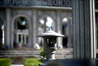 Close-up of lamp post over old architectural scenery 