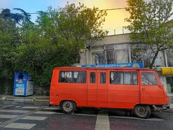 Vintage car on street in city against sky