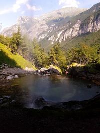 Scenic view of lake and mountains against sky