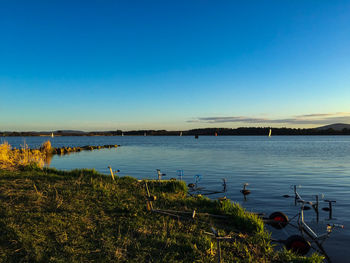 Scenic view of calm sea against clear sky