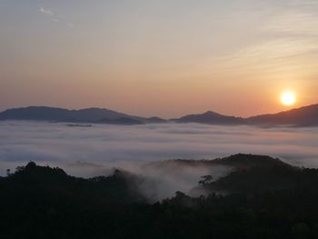 Scenic view of silhouette mountains against sky during sunset