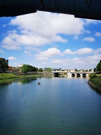 View of bridge over river against cloudy sky