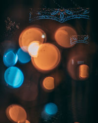 Close-up of illuminated glasses on table