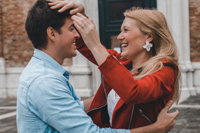 Side view of a smiling young couple