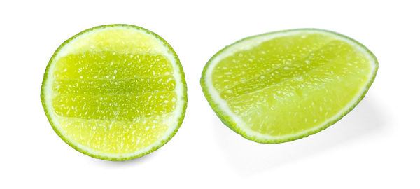 Close-up of green fruits against white background