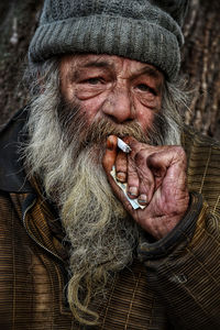Portrait of senior man smoking cigarette