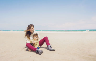 Woman on beach against sky