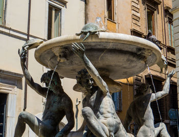 Low angle view of horse sculpture on building