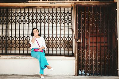 Portrait of young woman sitting outdoors