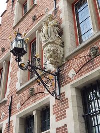 Low angle view of street light against building