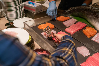 High angle view of man preparing food on table