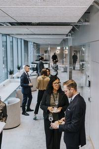 Senior businesswoman with young businessman discussing during conference