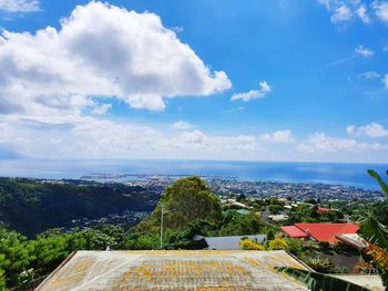 High angle view of townscape by sea against sky