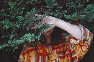 Midsection of woman holding plant