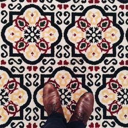 Low section of woman standing on tiled floor