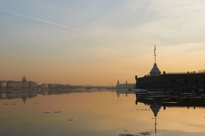 Reflection of building in water at sunset