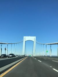 View of suspension bridge against clear blue sky