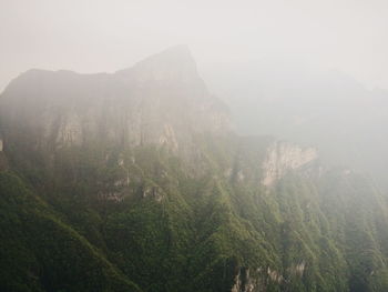Scenic view of mountains against sky during foggy weather