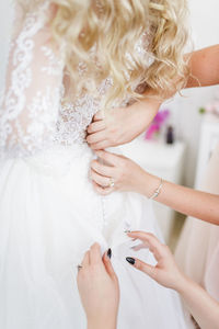 Midsection of woman holding hands