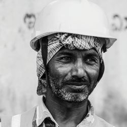 Close-up of mature man wearing hardhat