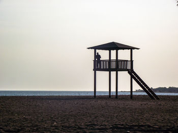 Lifeguard hut on beach against clear sky