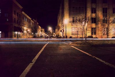 Illuminated city street at night