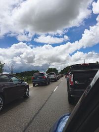 Cars on road against sky