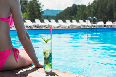 Low section of woman swimming in pool