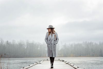 Woman walking along the beach looking thoughtful and calm in winter