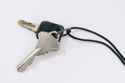 High angle view of metal chain against white background