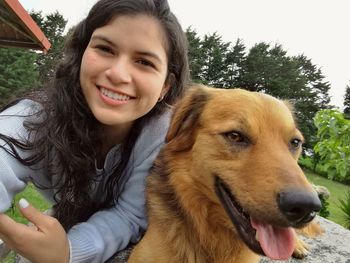 Portrait of smiling young woman with dog