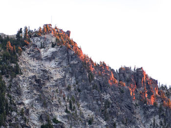 Rock formations on mountain against clear sky