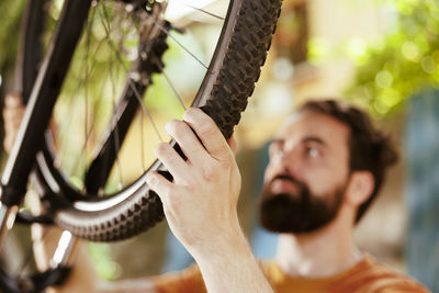 Cropped hand of man repairing bicycle