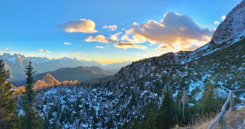 Scenic view of snowcapped mountains against sky during sunset