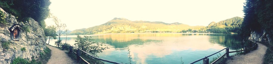 Scenic view of lake and mountains against clear sky