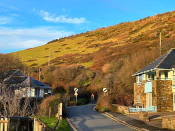 Houses by mountain against sky