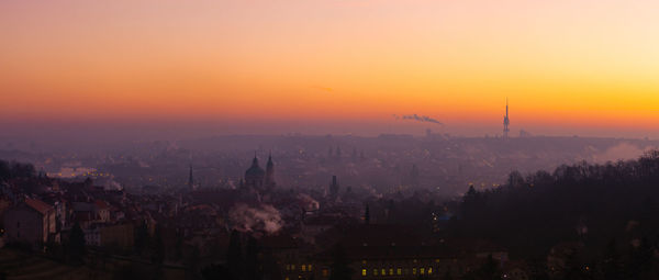 High angle view of buildings in city during sunset