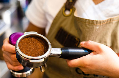 Close-up of hand holding coffee cup