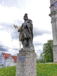 Low angle view of statue against cloudy sky