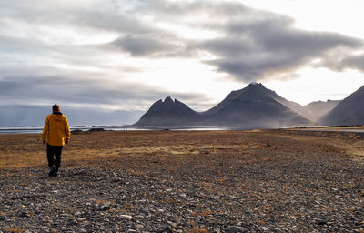 Rear view of man standing on mountain