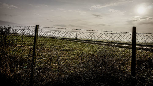 Chainlink fence at sunset